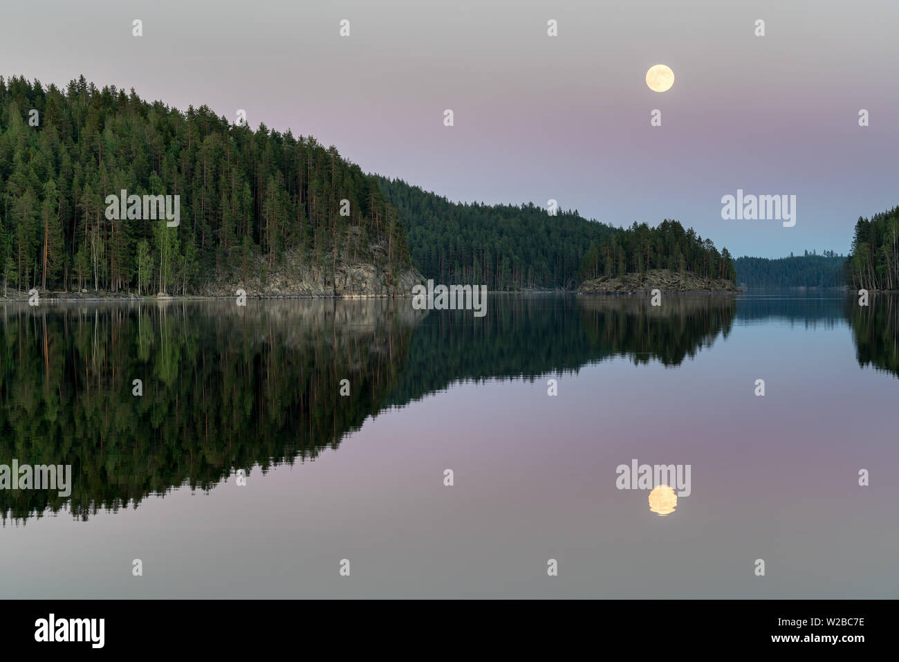 Luna che sorge al tramonto nel parco nazionale di Kolovesi, Enonkoski, Finlandia Foto Stock