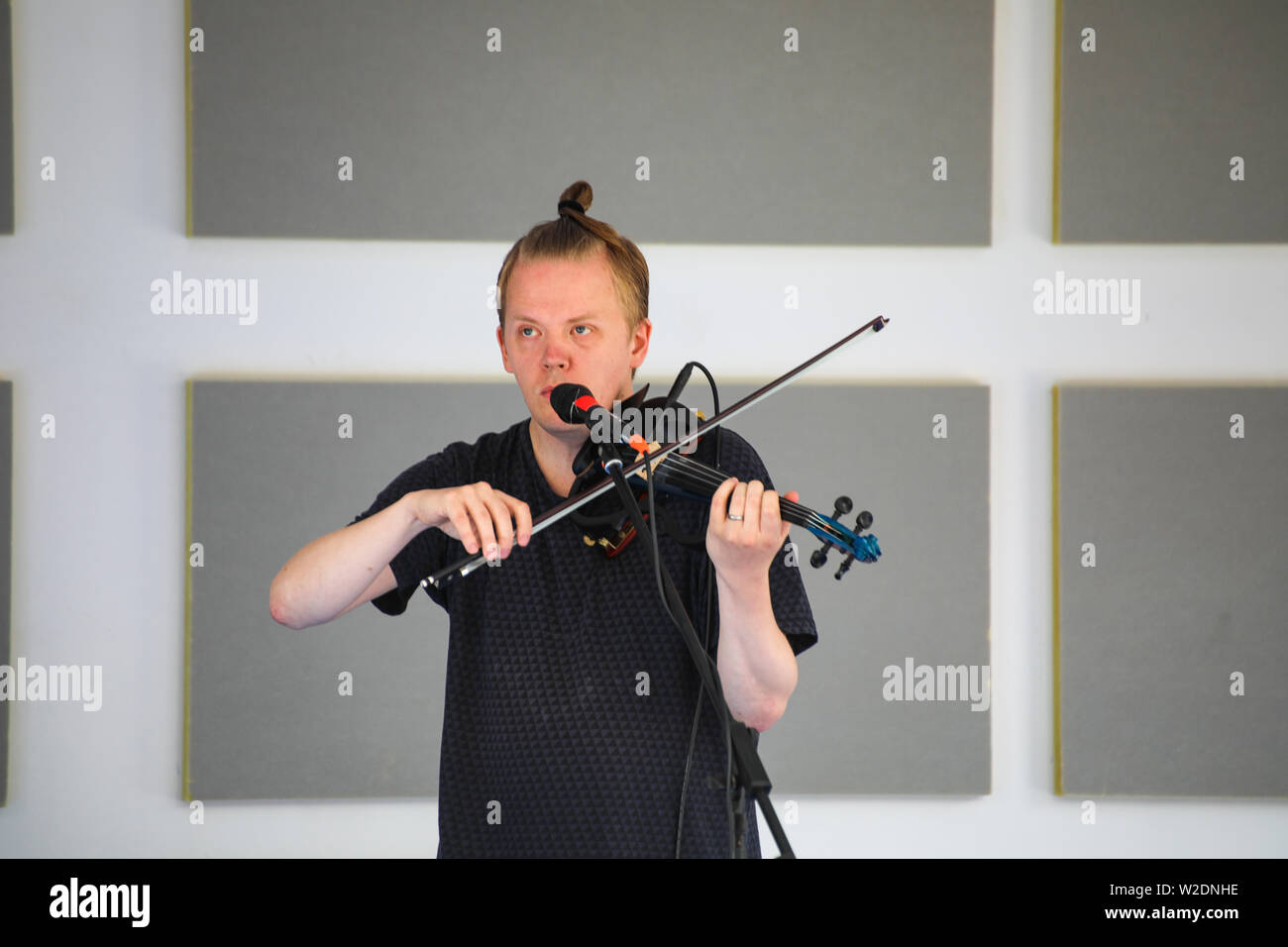 Direttore artistico del Festival, Pekka Kuusisto dando una strada libera concerto con violino elettrico e materiale improvvisato in Järvenpää, Finlandia Foto Stock