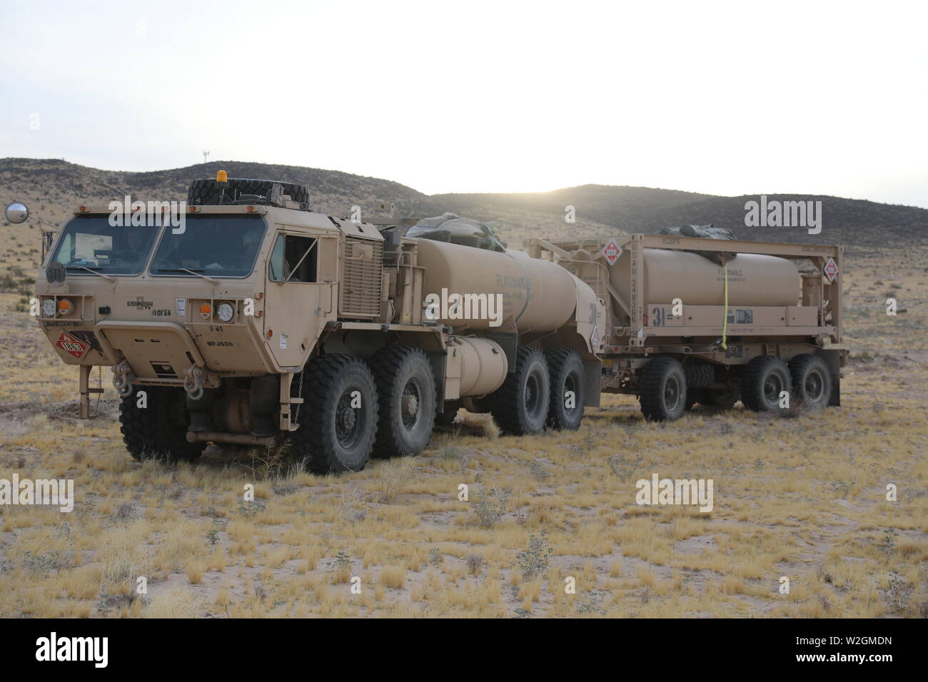I soldati del primo squadrone, 150° reggimento di cavalleria, 30 vigili del Team di combattimento, West Virginia Guardia nazionale, utilizzare una pesante Mobilità Estesa Tactical carrello per trasportare il carburante per sete serbatoi, HMMWVs e altri veicoli tattici durante il funzionamento Hickory Sting a Fort Irwin, California, il 7 luglio 2019. Funzionamento Hickory pungiglione è una decisa azione rotazione incentrato sulla produzione combinata di bracci e manovra gunnery collettiva presso il Centro Nazionale di Allenamento, Fort Irwin, California, al fine di convalidare le capacità del trentesimo nell'ambiente di formazione e fornire globalmente un sensibile brigata pronto per distribuire, f Foto Stock