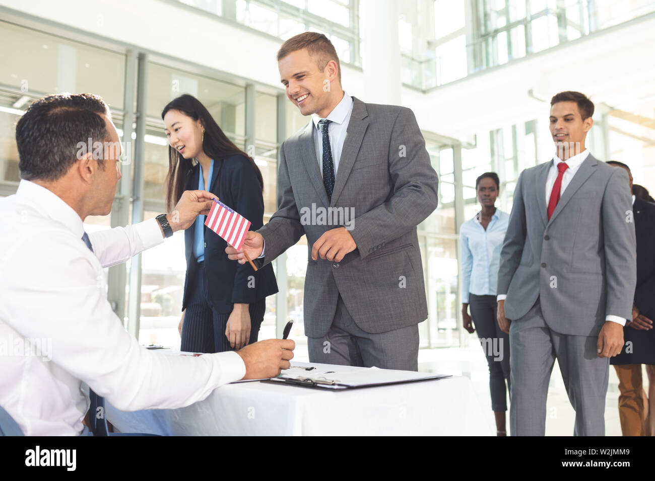 Gruppo di diverse persone di affari in attesa in linea per la registrazione Foto Stock