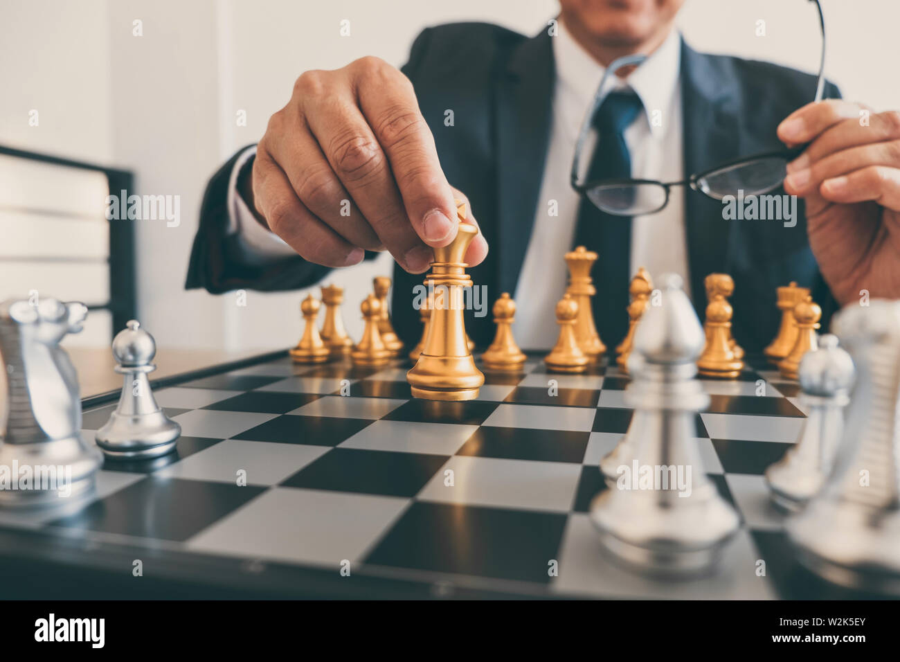 Imprenditore leadership giocando a scacchi e pensare piano strategico su crash di rovesciare la squadra opposta e analizzare lo sviluppo per il successo di corp Foto Stock