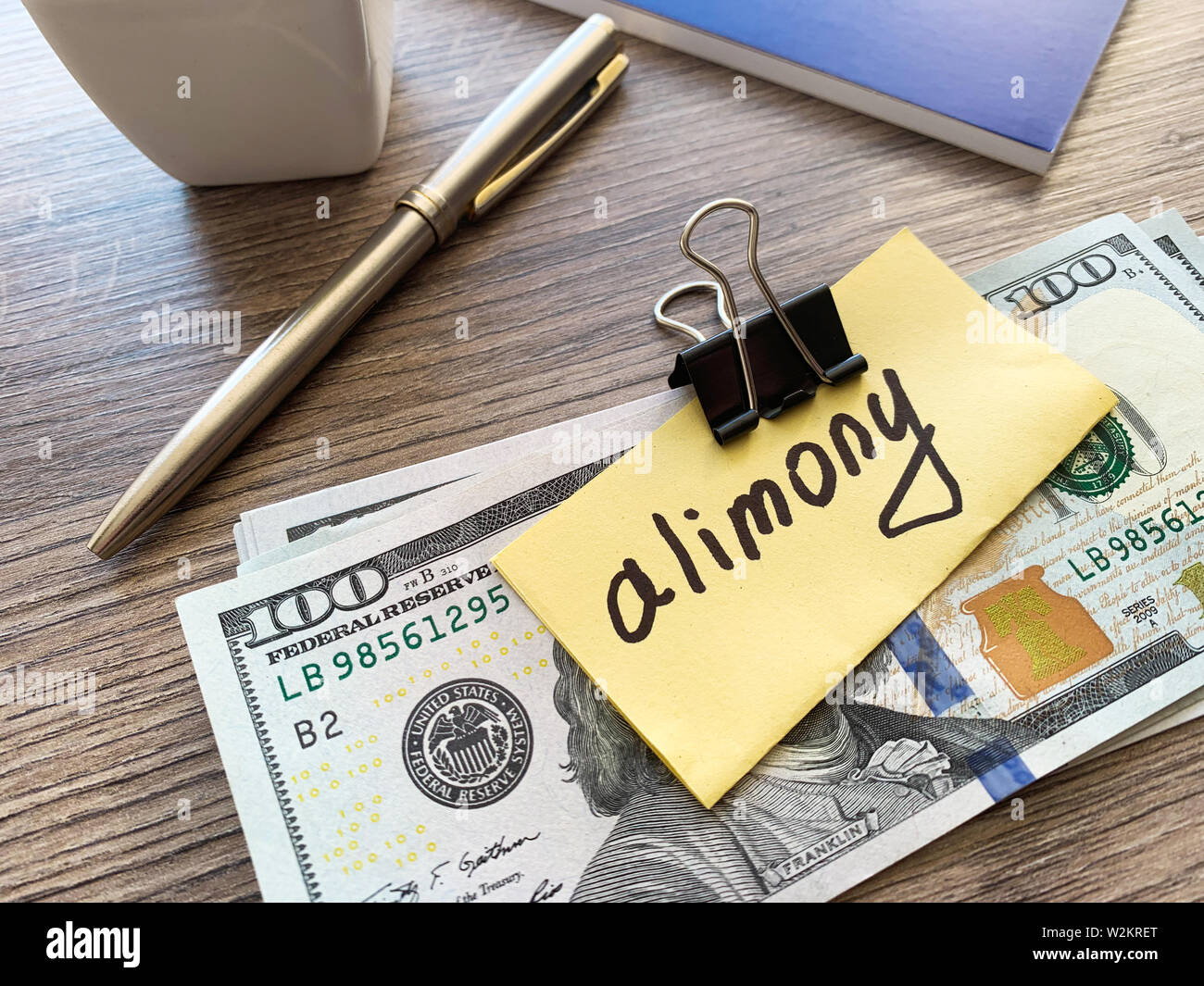 Pagamenti alimony. Pila di dollari con firmare assegni alimentari e denaro. Il divorzio e il concetto di separazione Foto Stock