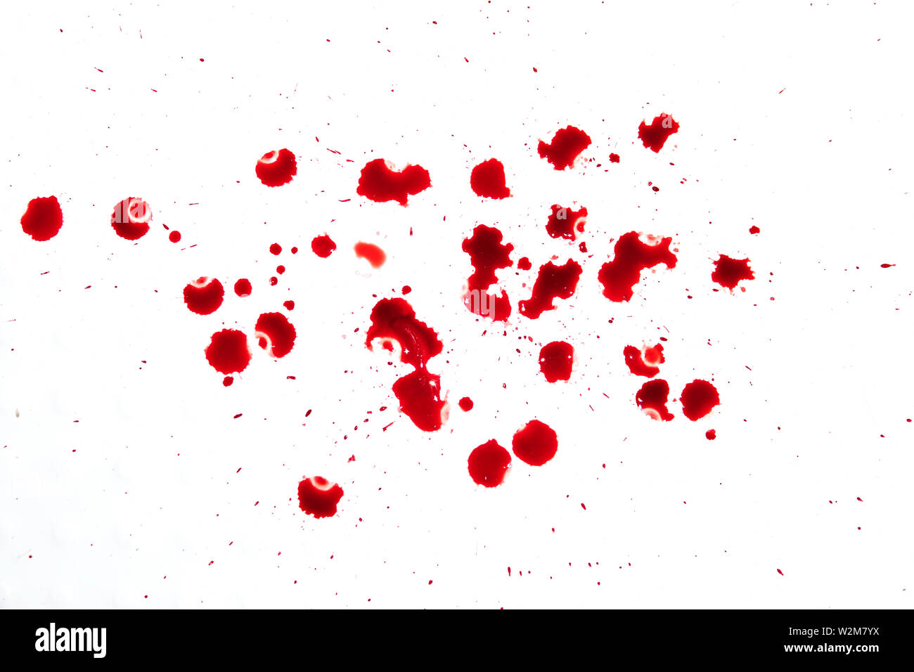 Il gocciolamento rosso sangue splash, l' orrore e la nozione di emergenza, isolato su sfondo bianco. Con tante gocce di sangue rosso sul pavimento bianco Foto Stock