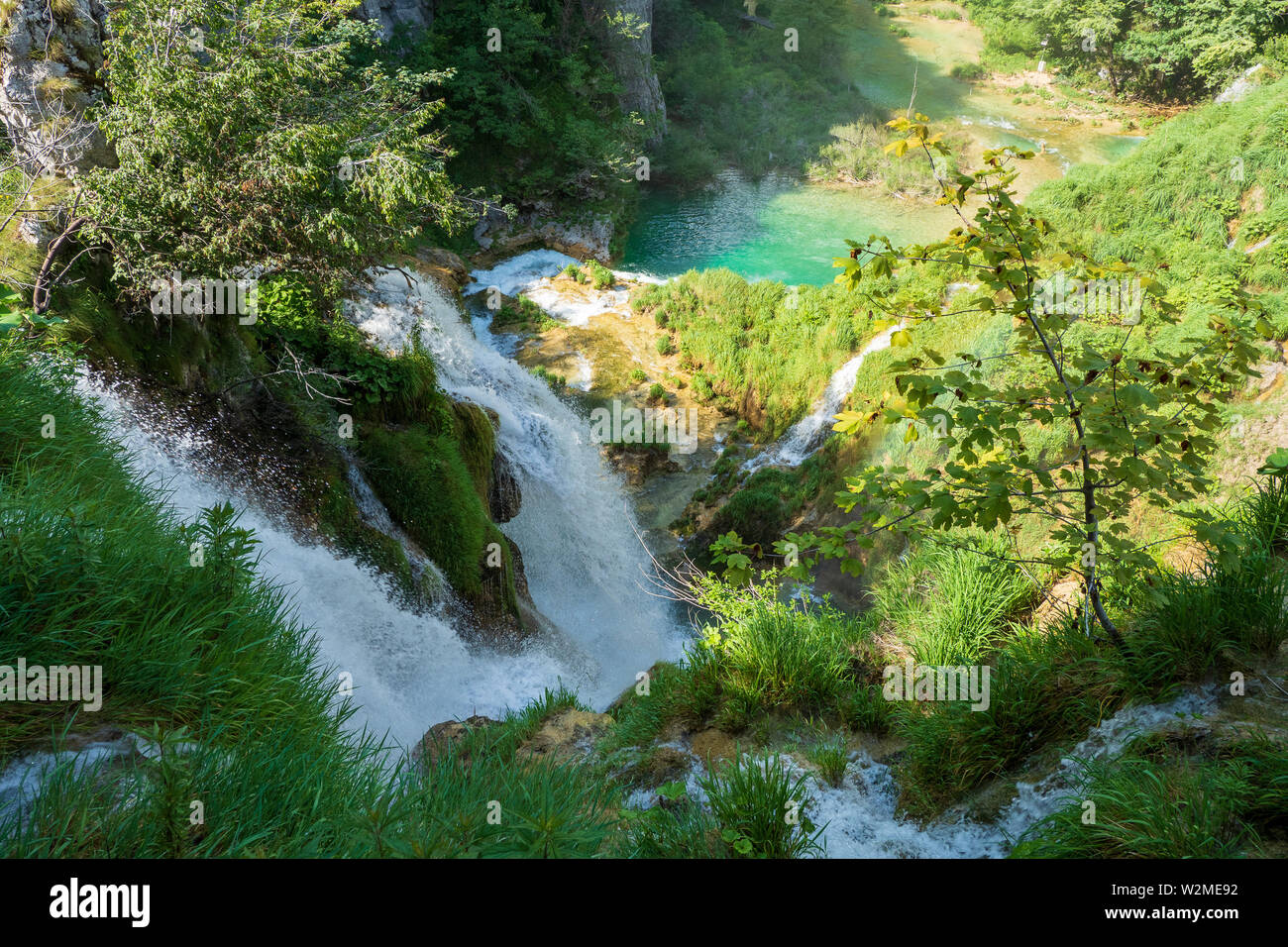 Splendida vista del fragoroso di masse di acqua correndo sopra il bordo di una scogliera presso il Parco Nazionale dei Laghi di Plitvice, Plitvička Jezera, Croazia Foto Stock