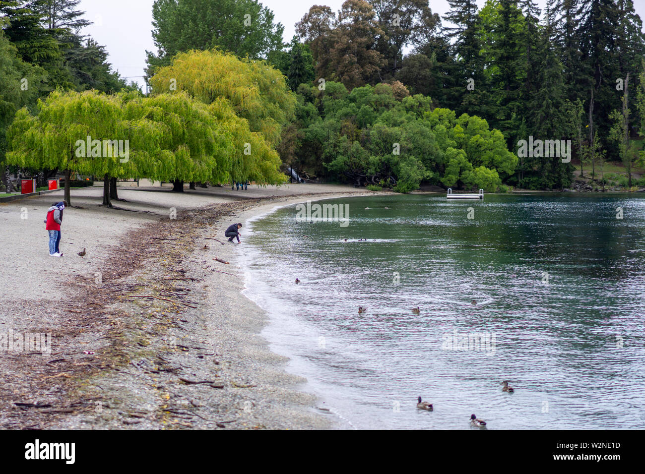 I turisti sul litorale della spiaggia cittadina del Lago Wakatipu in Queenstown, Isola del Sud della Nuova Zelanda Foto Stock