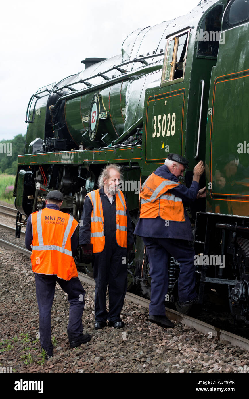 L'equipaggio di supporto della Marina Mercantile classe locomotiva a vapore "Clan" Linea indossando hi-vis gilet Foto Stock