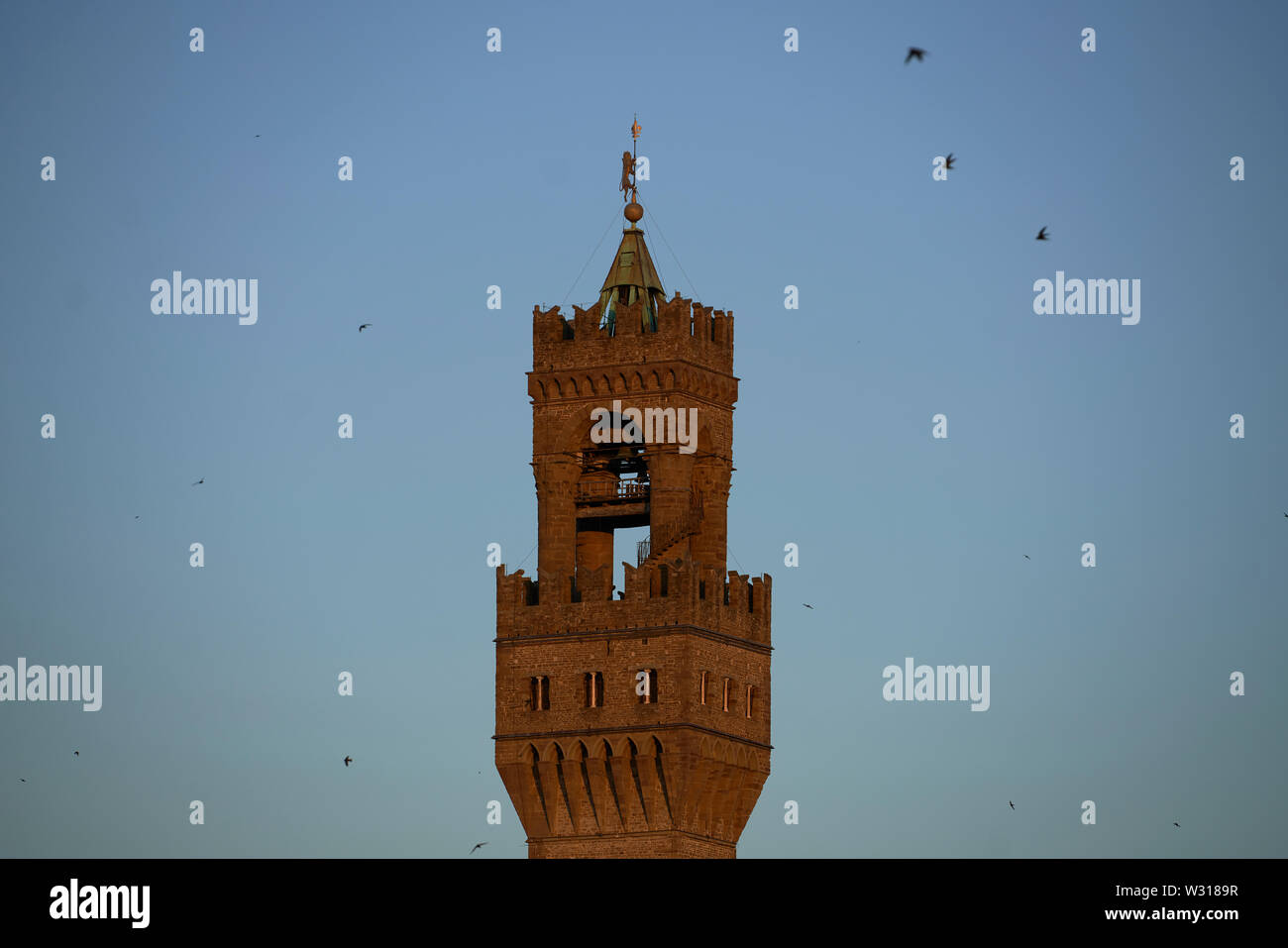 Torre Campanaria di Palazzo Vecchio a Firenze (Firenze) Italia al tramonto, con tetti in primo piano. Foto Stock