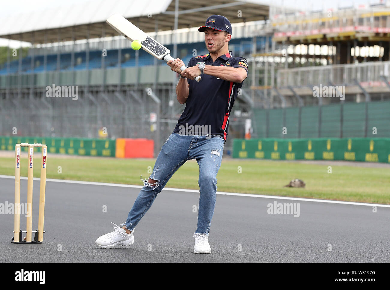 Aston Martin driver Red Bull Pierre Gasly gioca il cricket sul dritto del traguardo, durante una giornata di anteprima per il Gran Premio di Gran Bretagna a Silverstone, Towcester. Foto Stock