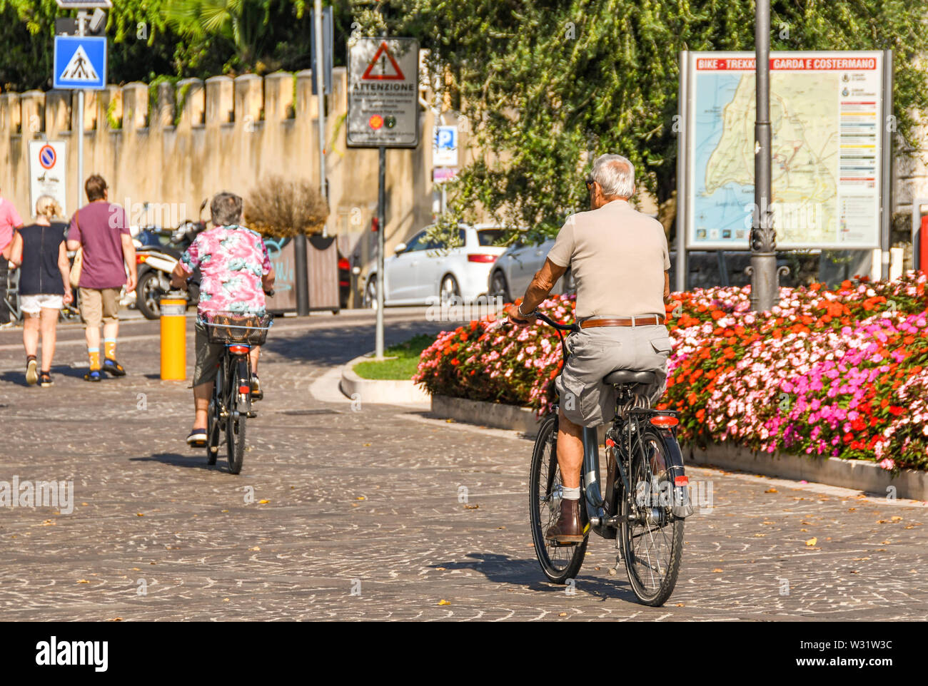 Il LAGO DI GARDA, Italia - Settembre 2018: uomo maturo e la donna in bicicletta sul lago di Garda sul Lago di Garda. Foto Stock