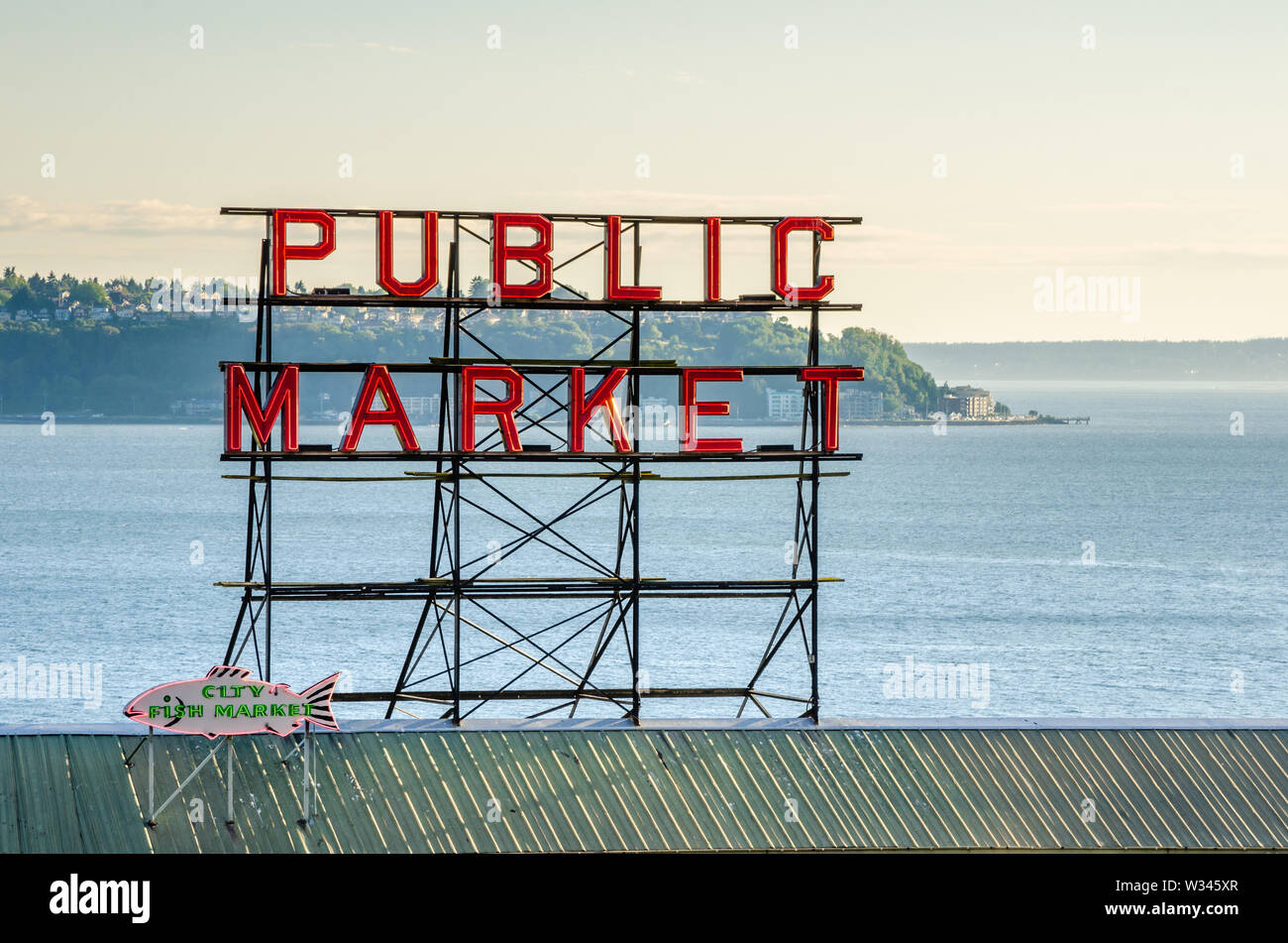 Il Mercato di Pike Place segno con una nebbia bay in background al tramonto Foto Stock