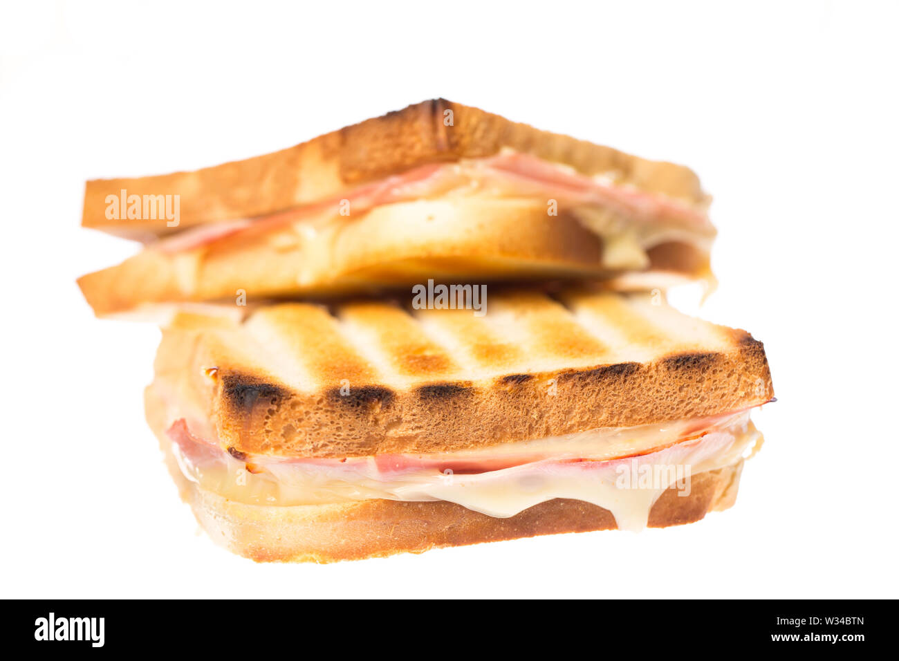 Due prosciutto formaggio toast su ogni altro su sfondo bianco Foto Stock
