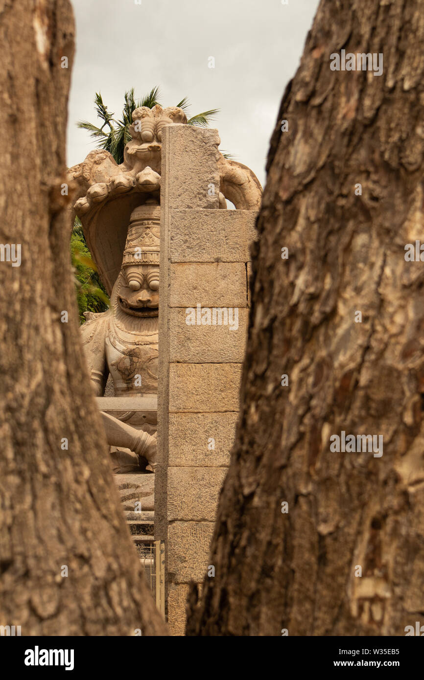 Ugra Narsimha o Lakshmi Narsimha catturati attraverso Windows di Hampi. L'uomo-lion avatar del signore Vishnu - seduti in una posizione di yoga Foto Stock