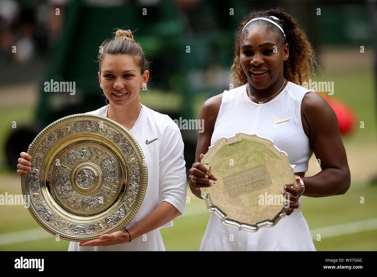 Simona Halep (sinistra) festeggia con il suo trofeo dopo aver vinto il singolare femminile finale, al fianco di runner-up Serena Williams, il giorno dodici dei campionati di Wimbledon al All England Lawn Tennis e Croquet Club, Wimbledon. Foto Stock