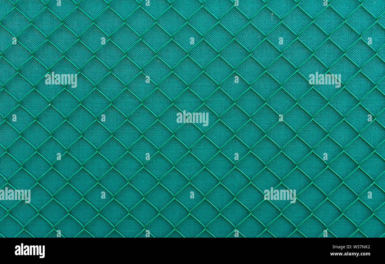 Filo verde scherma con un panno verde dietro Foto Stock