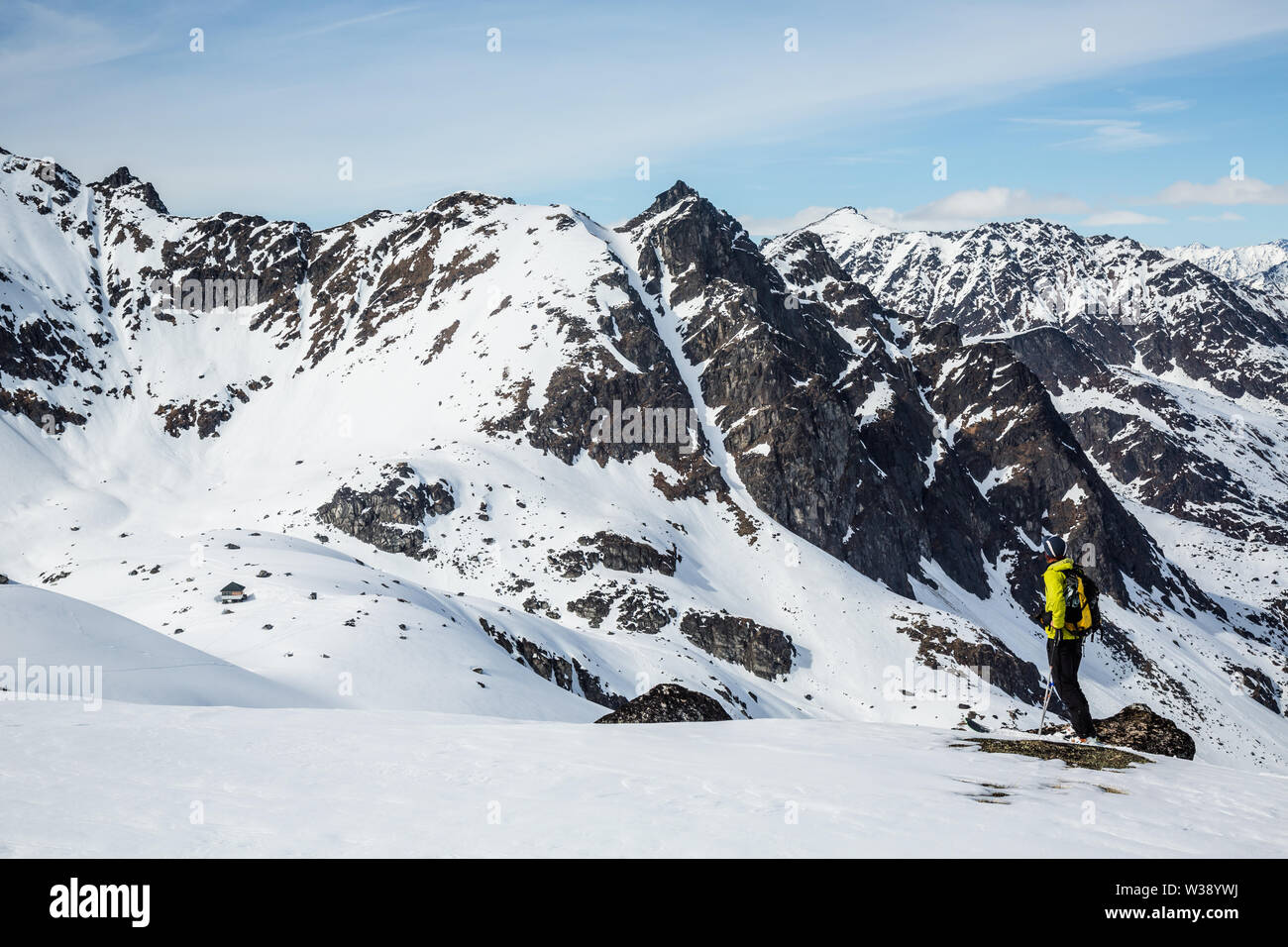 Sciatore nel backcountry montagne della gamma Talkeetna. Scouting di gran lunga le linee e couloirs su picchi remoti. Foto Stock