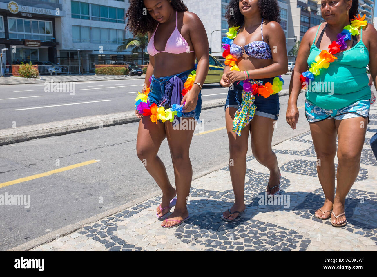 RIO DE JANEIRO - 28 febbraio 2017: Donne usura color arcobaleno leis camminando sul marciapiede modellato di Ipanema a Farme de Amoedo gay-sezione. Foto Stock