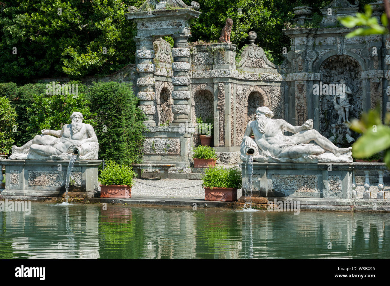 Marlia, Lucca, Italia - 2018 25 Maggio: Il giardino di limoni con grande piscina ornamentali e balaustra in pietra; due statue di Giganti che rappresentano gli enti locali ri Foto Stock