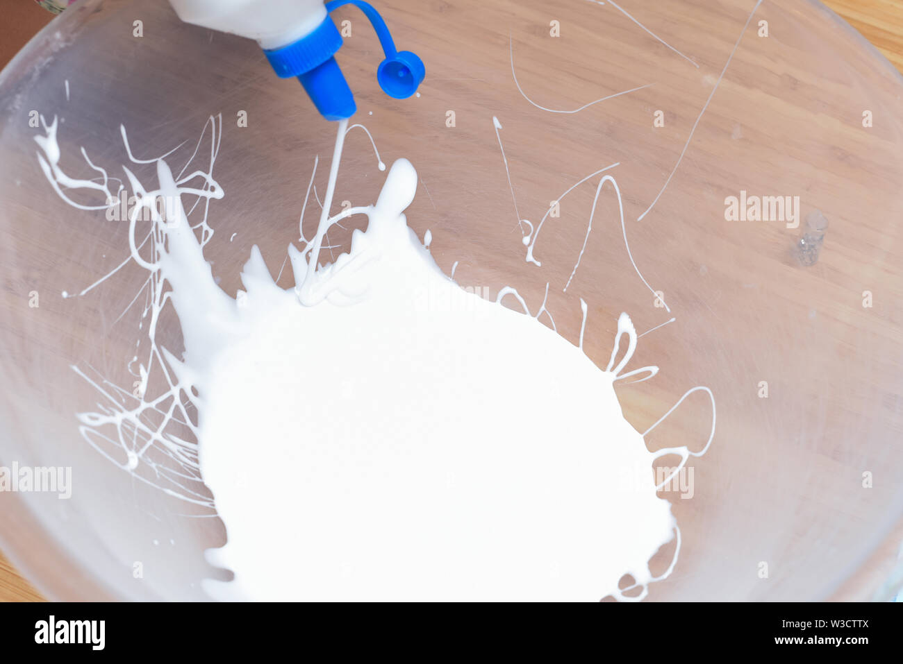 I bambini a casa fare in casa il fango. Focus sulle mani la miscelazione degli ingredienti Foto Stock