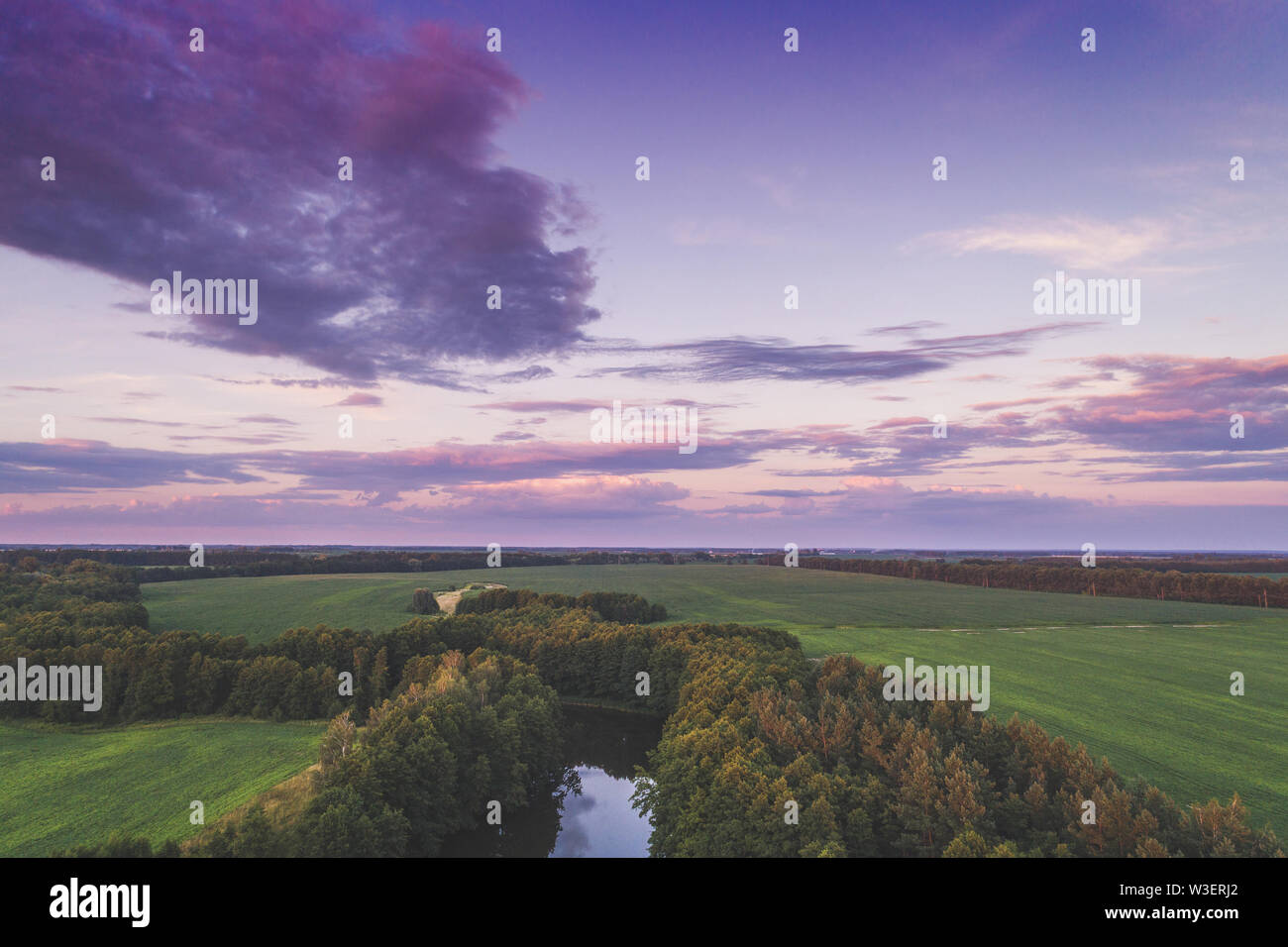 Magico tramonto sulla campagna. Fiume con alberi sulle rive. Paesaggio rurale Foto Stock