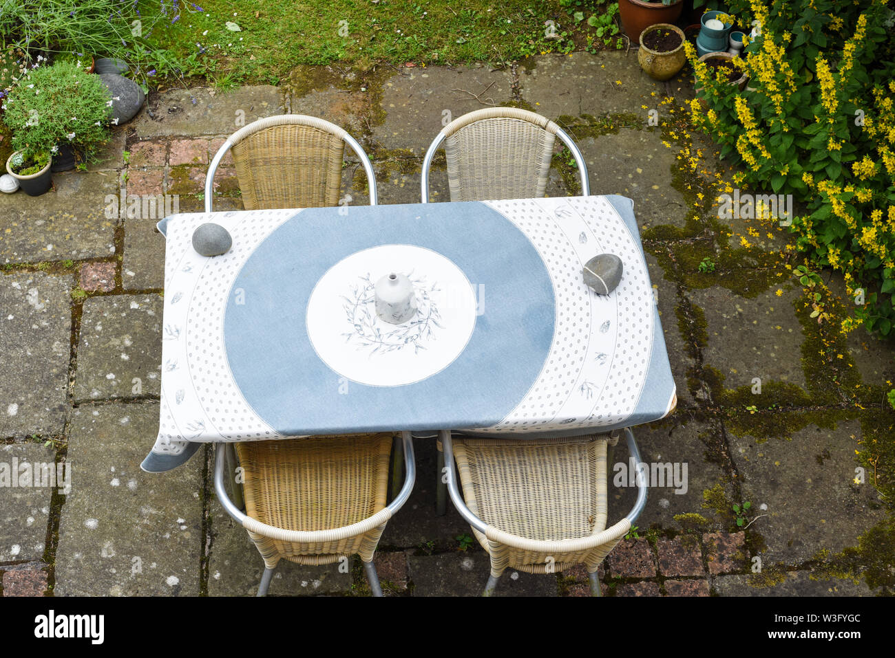 Stile rustico area patio giardino con tavolo e sedie per mangiare all'aperto area Foto Stock