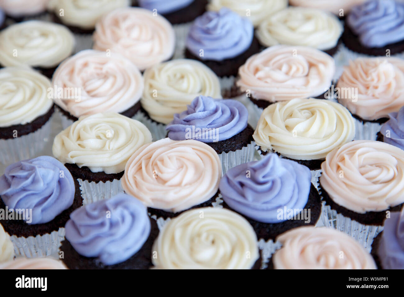 Viola, di crema e bianco tortini di cioccolato decorate e pronto per essere consumato Foto Stock
