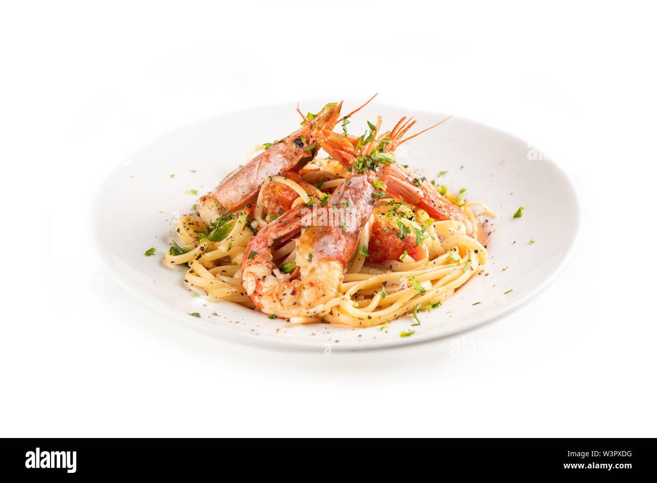 Linguine con aglio e gamberoni su una piastra su sfondo whita Foto Stock