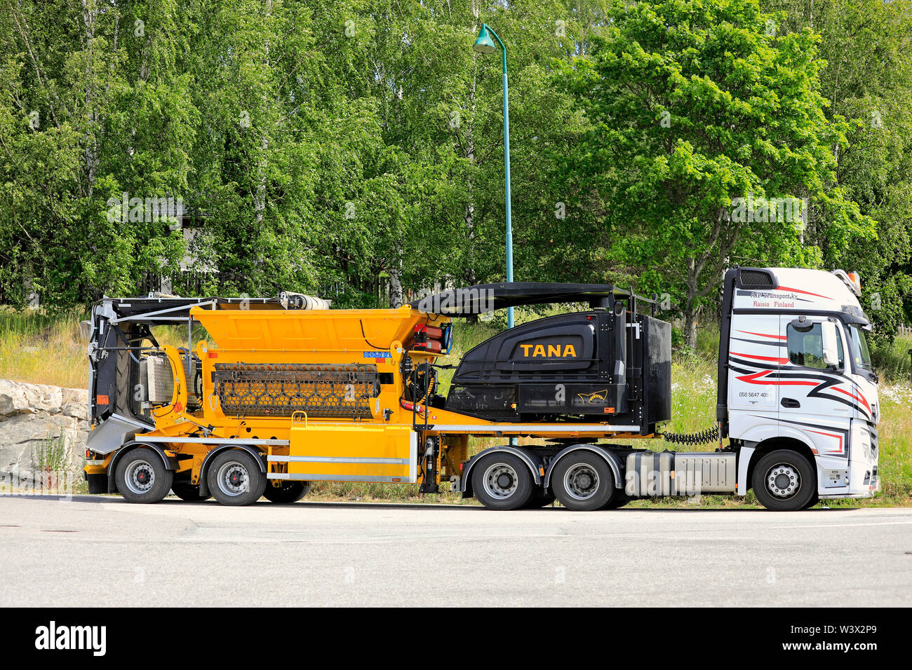 Salo, Finlandia. Giugno 29, 2019. Mercedes-Benz Actros 2653 carrello di trasporto AJP Ky alaggio TANA Shark rifiuti shredder parcheggiato su un arresto carrello cantiere. Foto Stock