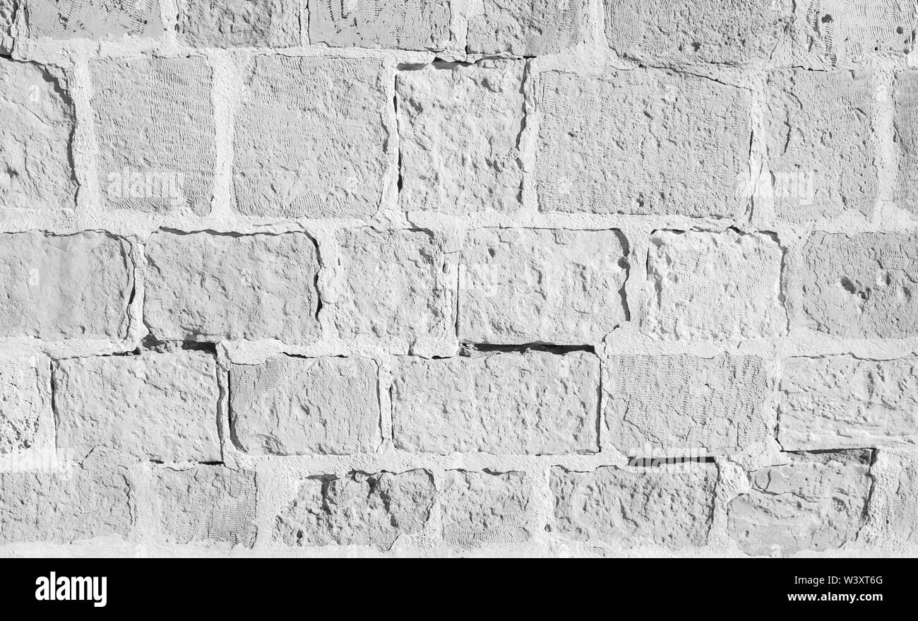 Bianco antico muro di pietra, vista frontale, foto di sfondo texture Foto Stock