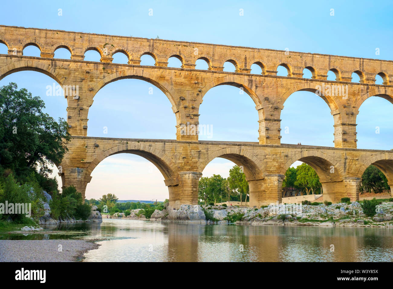 Pont du Gard acquedotto romano oltre il fiume Gard al tramonto, Gard Reparto, Languedoc-Roussillon, Francia Foto Stock