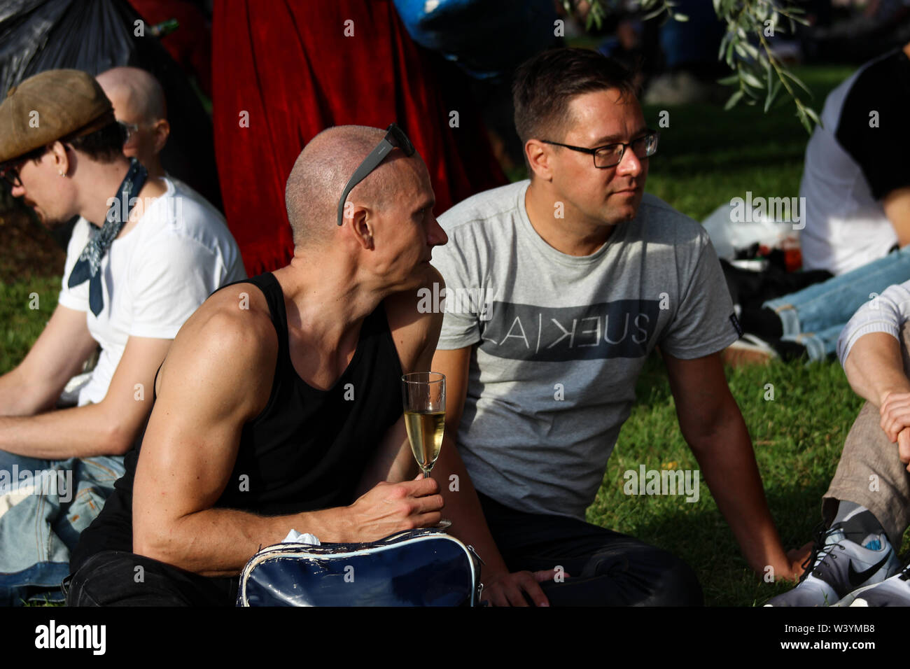 Gli uomini vivere il vino in sole serale a Kallio Block Party 2016 a Helsinki in Finlandia Foto Stock