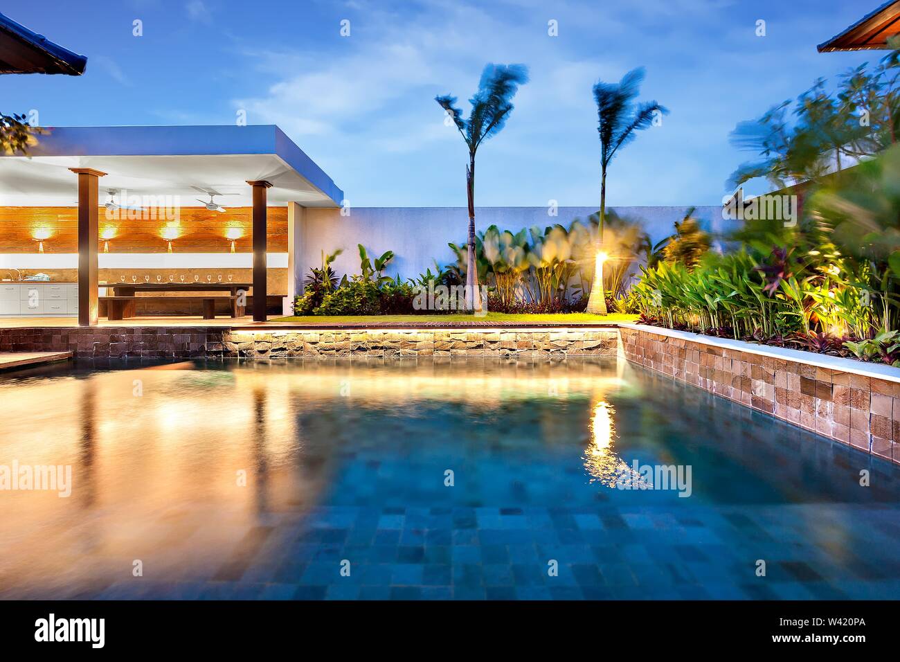 Moderna piscina si illumina con luci in un lussuoso albergo o casa di notte Foto Stock