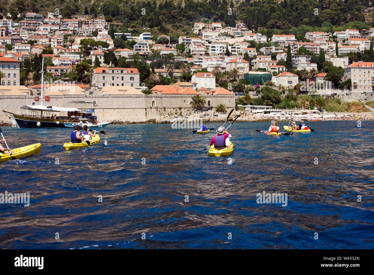 Persone kayak; vecchie mura della città, il Mare Adriatico; sport; ricreazione; gite in barca; divertimento; esercizio; Dubrovnik; Croazia; Europa; estate Foto Stock