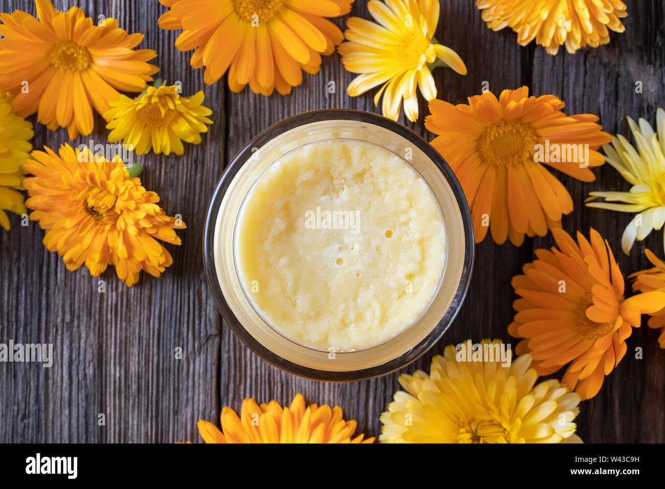 In casa unguento fatto dal burro di karitè e freschi di fiori di calendula, vista dall'alto Foto Stock