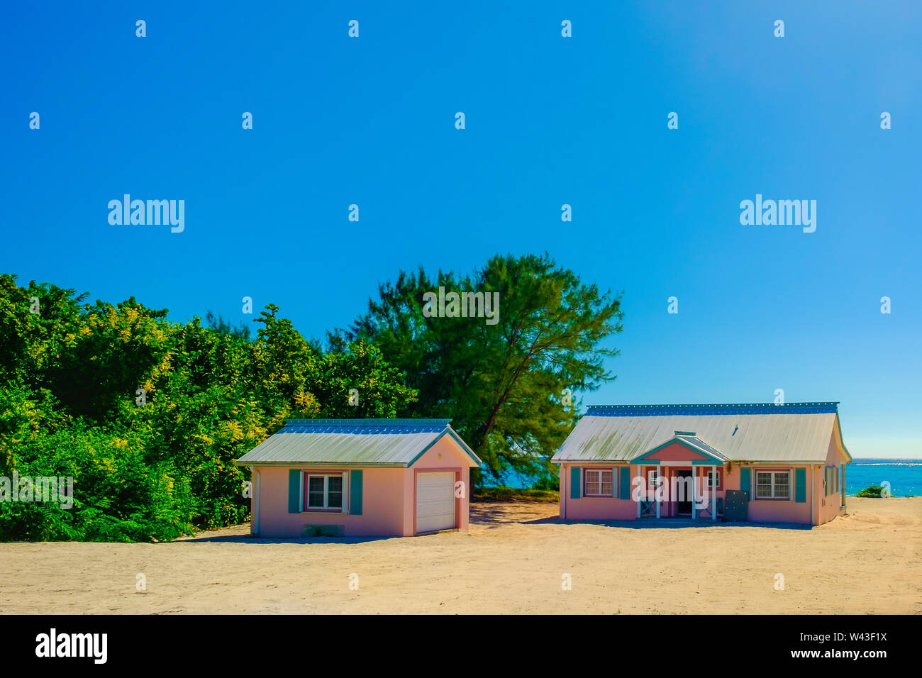 Little Cayman, Isole Cayman, Nov 2018, due Caribbean-Style rosa case sul foro del Sud Sound Foto Stock