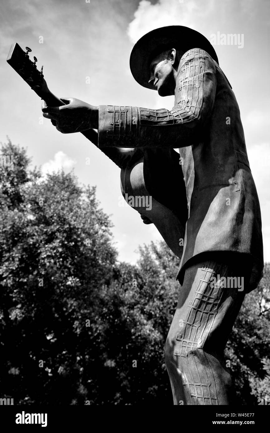 Verso l'alto angolo di visione della statua di Hank Williams, Sr, indossando la sua musica nota suit, strimpellamento la sua chitarra in Montgomery, AL, Stati Uniti d'America, in bianco e nero Foto Stock