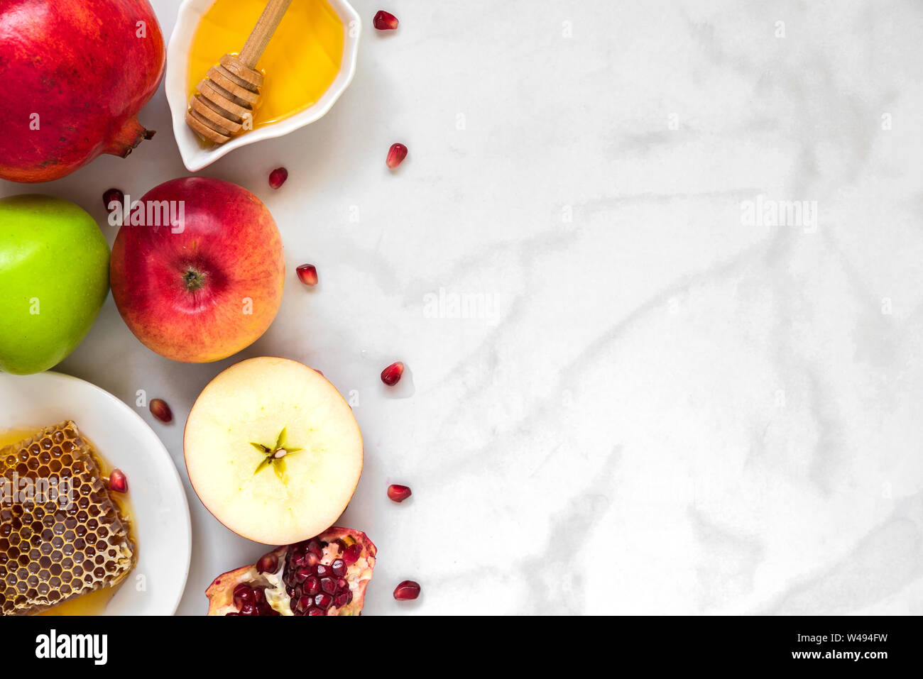 Festa ebraica di Rosh Hashana sfondo con miele, melograno e mele. flat laici. vista superiore con spazio di copia Foto Stock