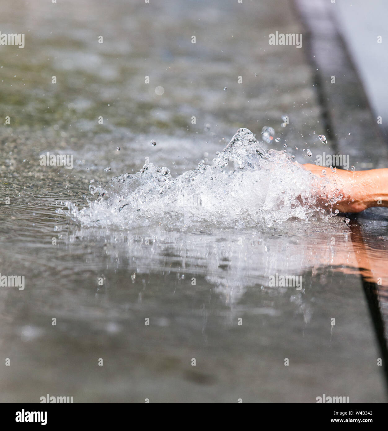 La mano toccare acqua su più fontane di Londra Foto Stock