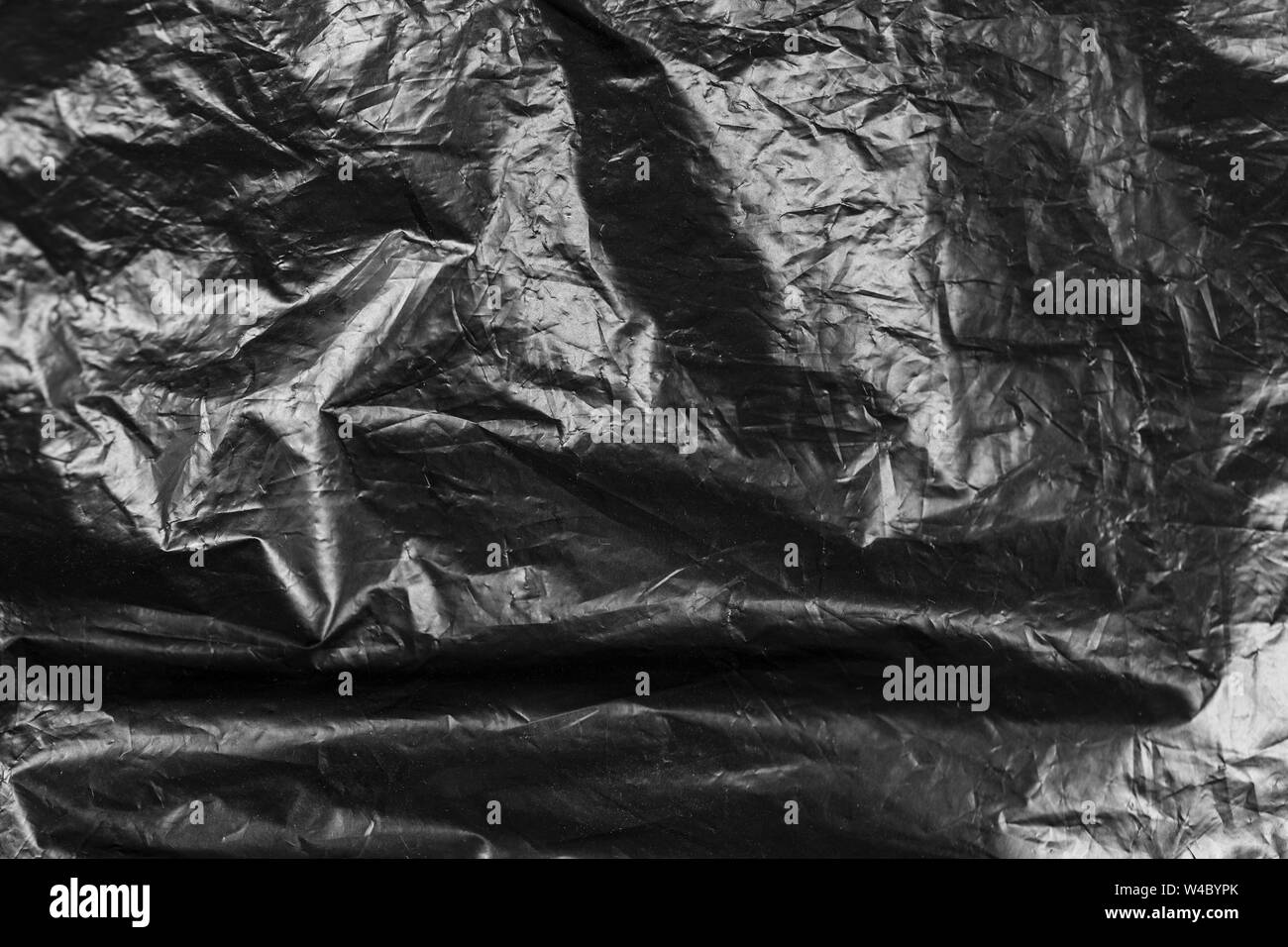 Polietilene nero spiegazzati. sfondo astratto. spazio per il testo Foto Stock