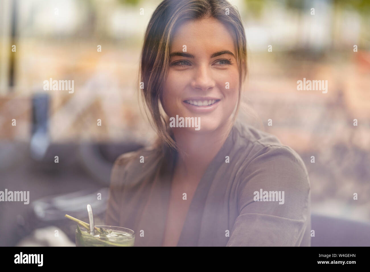 Giovane imprenditrice in un cafe, visto attraverso la finestra Foto Stock