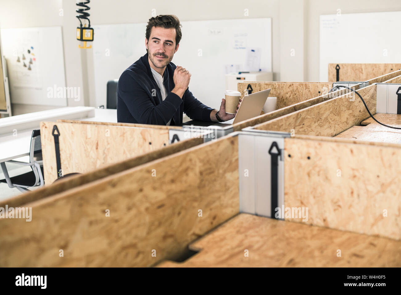 I giovani proprietari che lavorano in coworking space, utilizzando laptoop Foto Stock