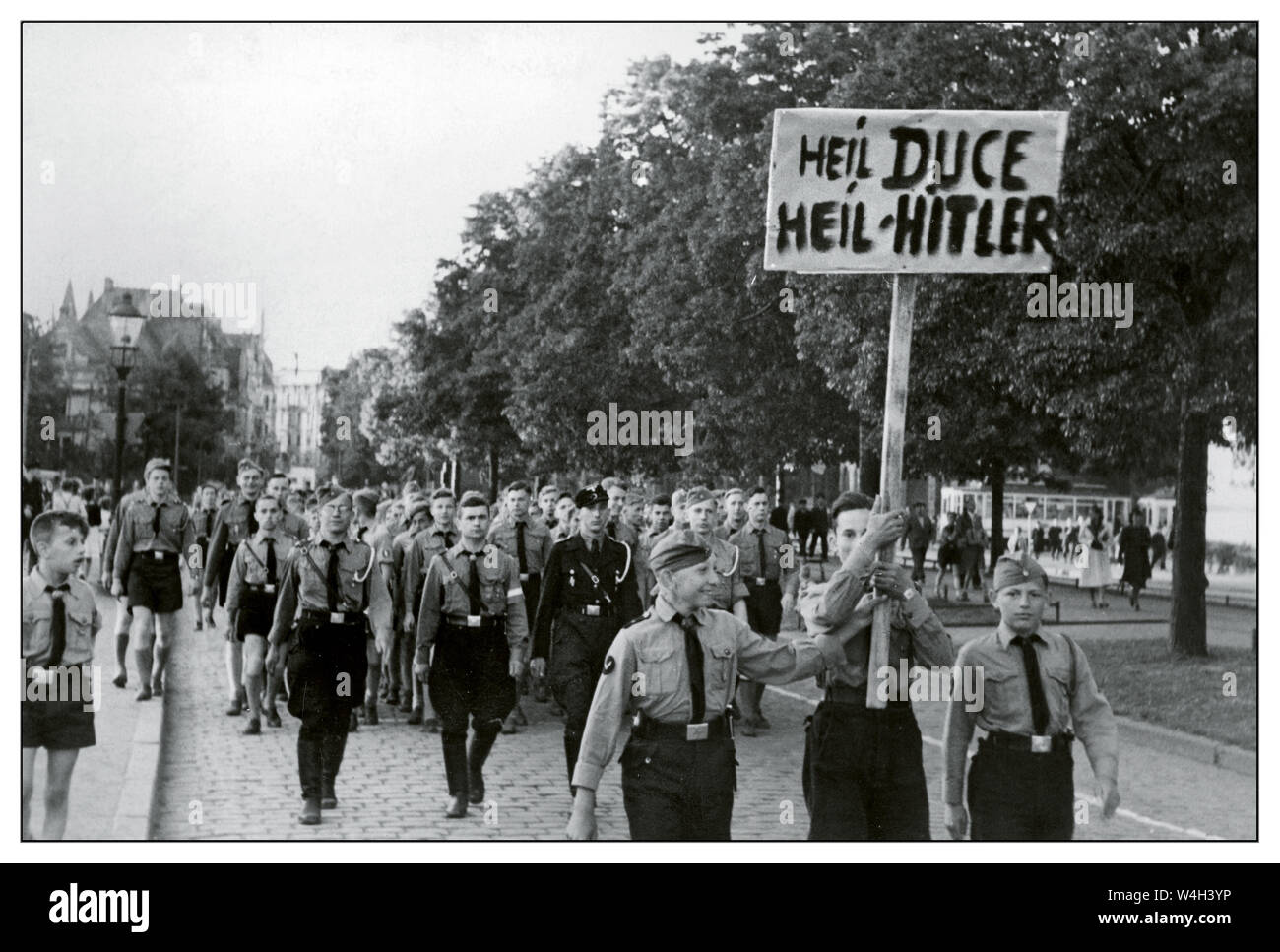 Gdańsk POLAND Vintage 1940's Nazi Hitler Youth March dimostrazione di Hitlerjugend sulla via della città di Danzica. "Heil Duce, Heil Hitler". Mostrando sostegno al facista Mussolini e al nazista Hitler nel 1940, Gdańsk Poland Foto Stock