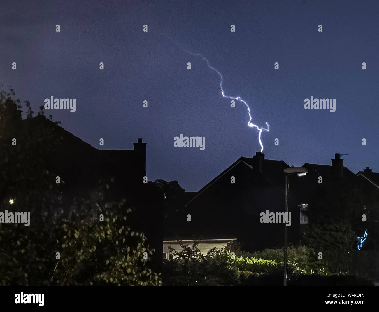 Il fulmine colpisce come un temporale passa sopra le case di Leeds, West Yorkshire. Il Regno Unito è previsto a bordo verso il suo sempre più calda giornata di luglio con il mercurio a causa di elevarsi al di sopra di 30C (86F). Foto Stock