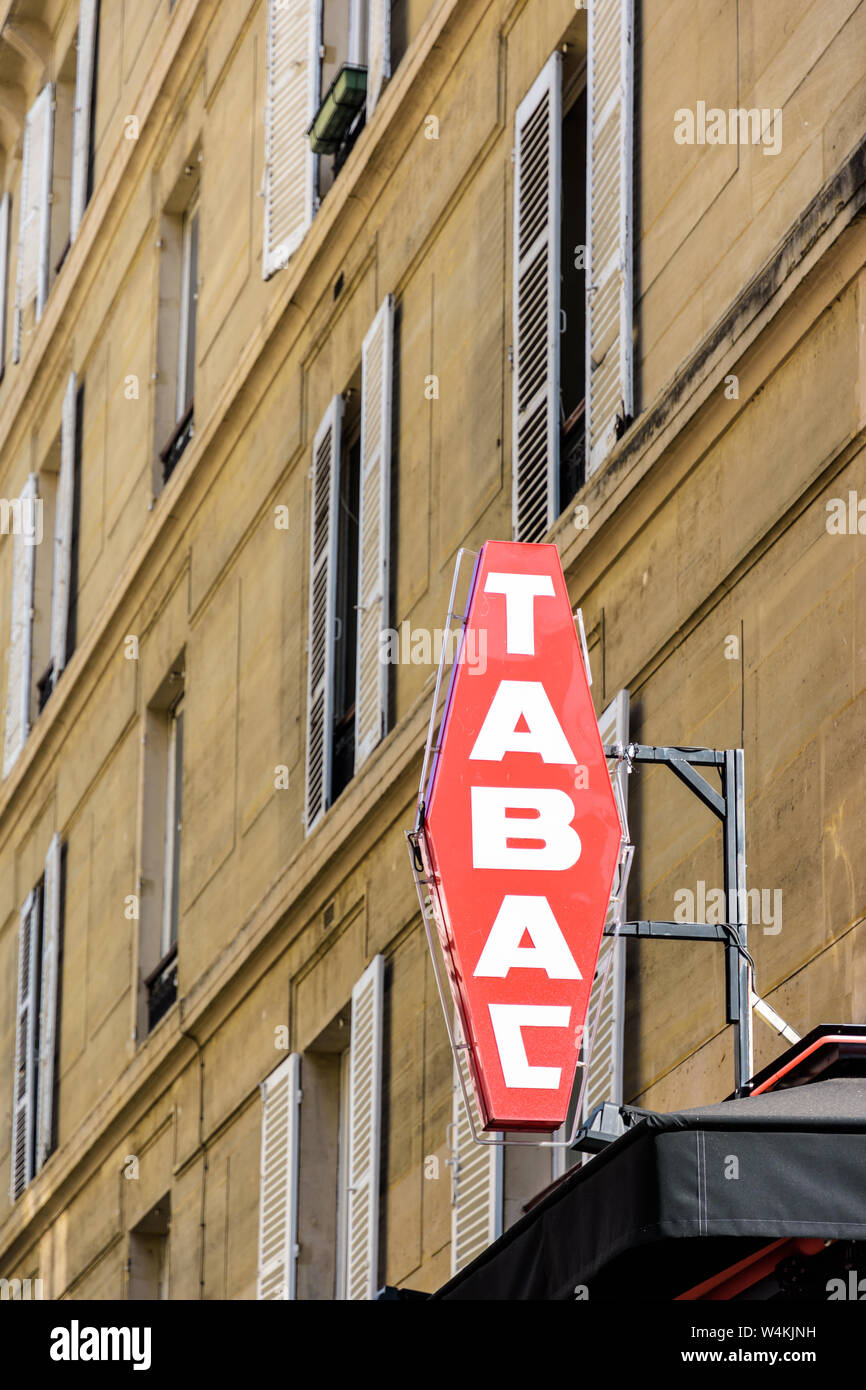 Rosso francese il tabacco shop segno bianco con scritte e un edificio in background. Foto Stock