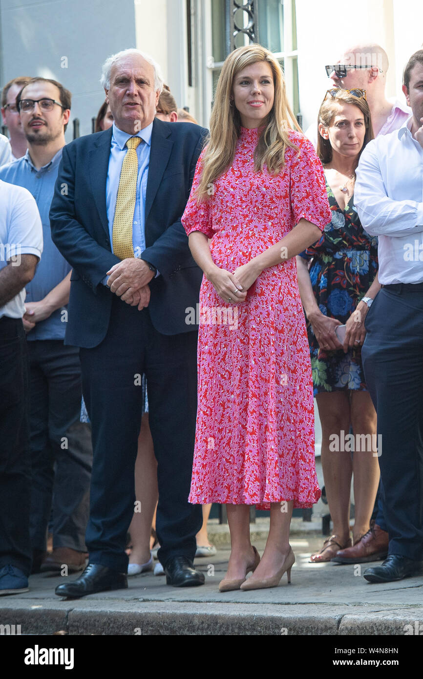 Il nuovo Primo Ministro Boris Johnson il partner Carrie Symonds attende per lui a fare un discorso al di fuori 10 Downing Street, Londra, dopo un incontro con la regina Elisabetta II e di accettare il suo invito a diventare Primo Ministro e formare un nuovo governo. Foto Stock