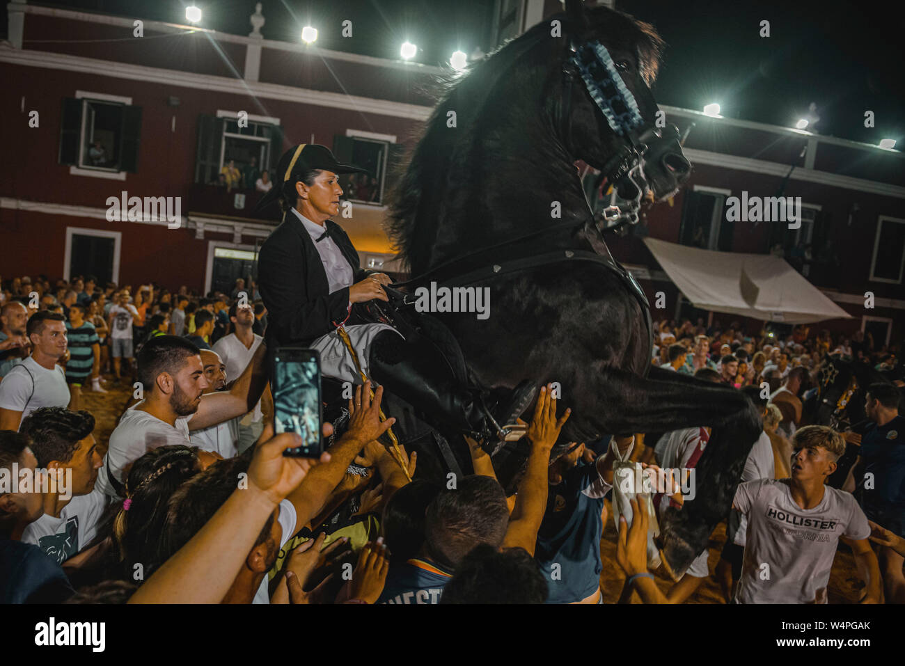 Barcellona, Spagna. 24 Luglio 2019: un 'caixer' (cavallo Cavaliere) culatte fino sul suo cavallo circondato da un tifo folla durante il tradizionale "Jaleo al Sant Jaume Festival in Es Castell Credito: Matthias Oesterle/Alamy Live News Foto Stock