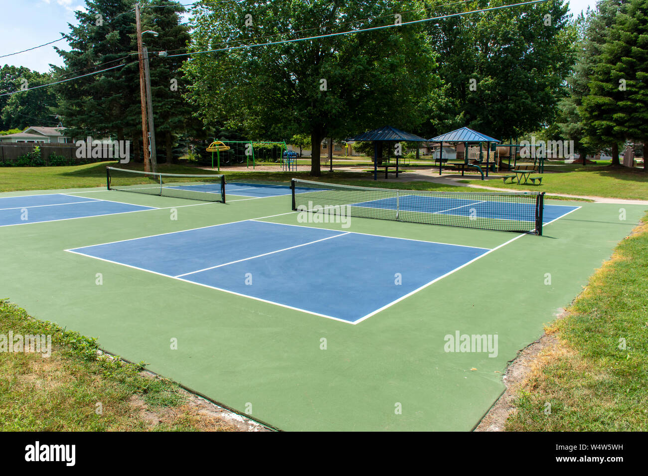 Sport ricreativo di pickleball corte nel Michigan, Stati Uniti d'America cercando in corrispondenza di un vuoto azzurro e verde nuovo tribunale in un parco all'aperto. Foto Stock