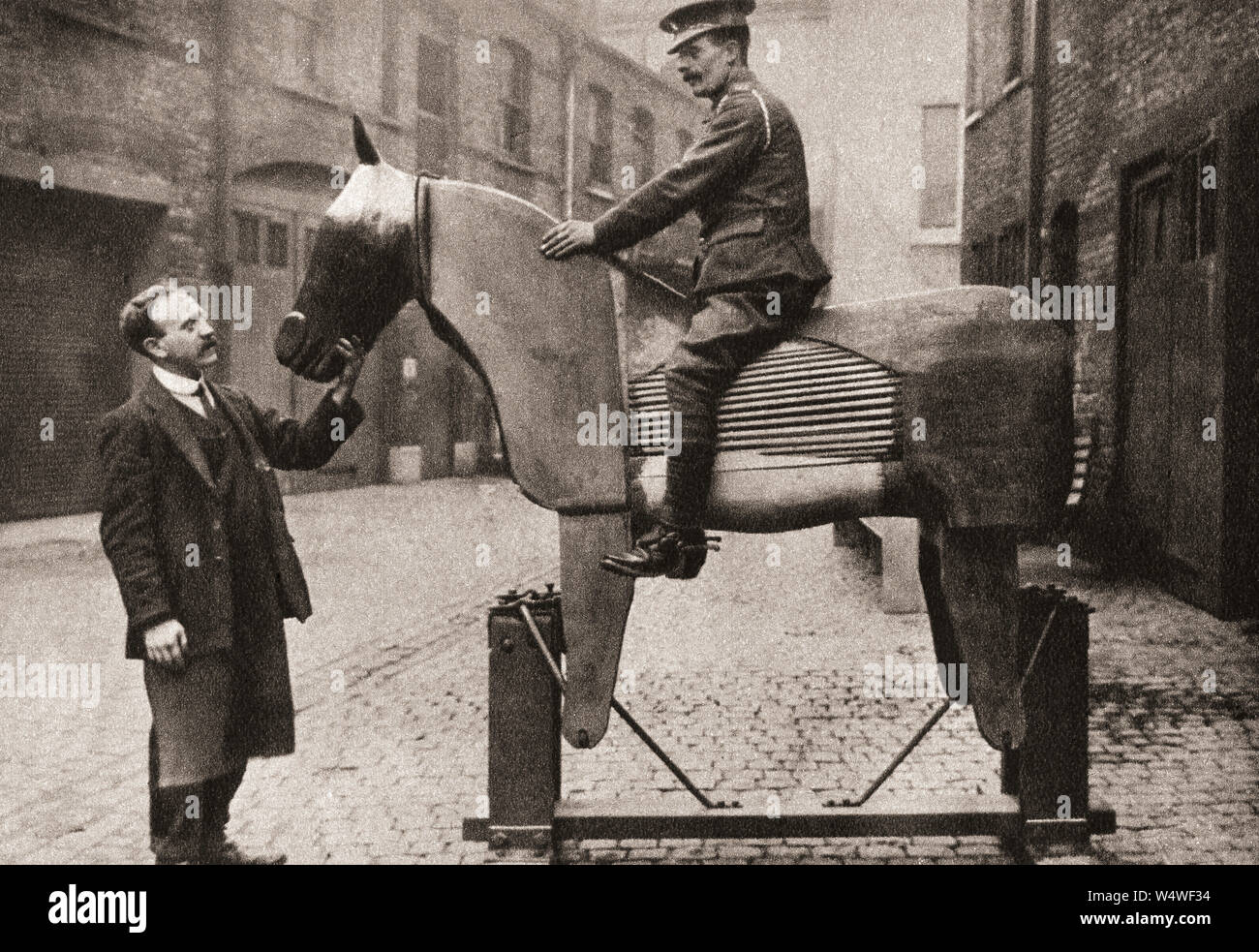 Addestramento reclute raw i rudimenti di cavalcare su fantoccio cavalli all'inizio della prima guerra mondiale nel 1914. Dalla rievocazione del secolo, pubblicato nel 1934. Foto Stock