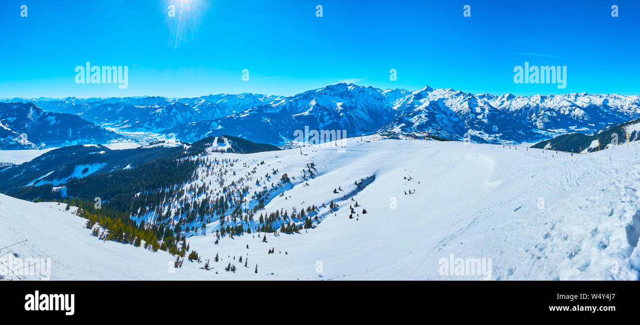 Osservare i dolci pendii innevati di Schmitten mount con comode piste da sci e racchette, foreste di abeti e rocce appuntite, Zell am See, Austr Foto Stock