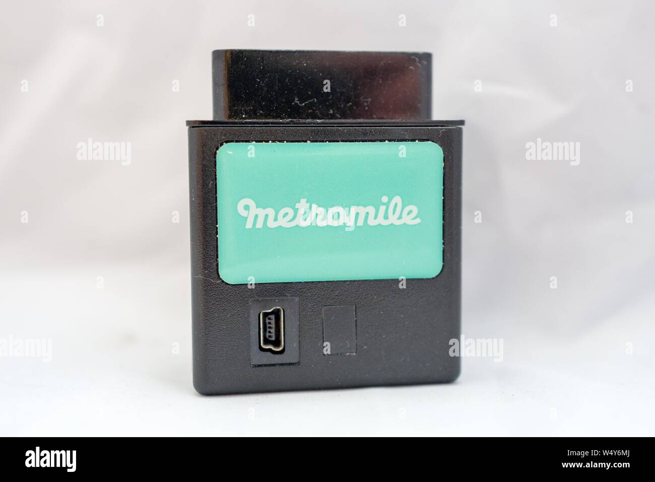Close-up di transponder con logo per computerizzato di pay-per-miglio auto insurance company Metromile isolati su sfondo bianco, San Ramon, California, il 7 maggio 2019. () Foto Stock