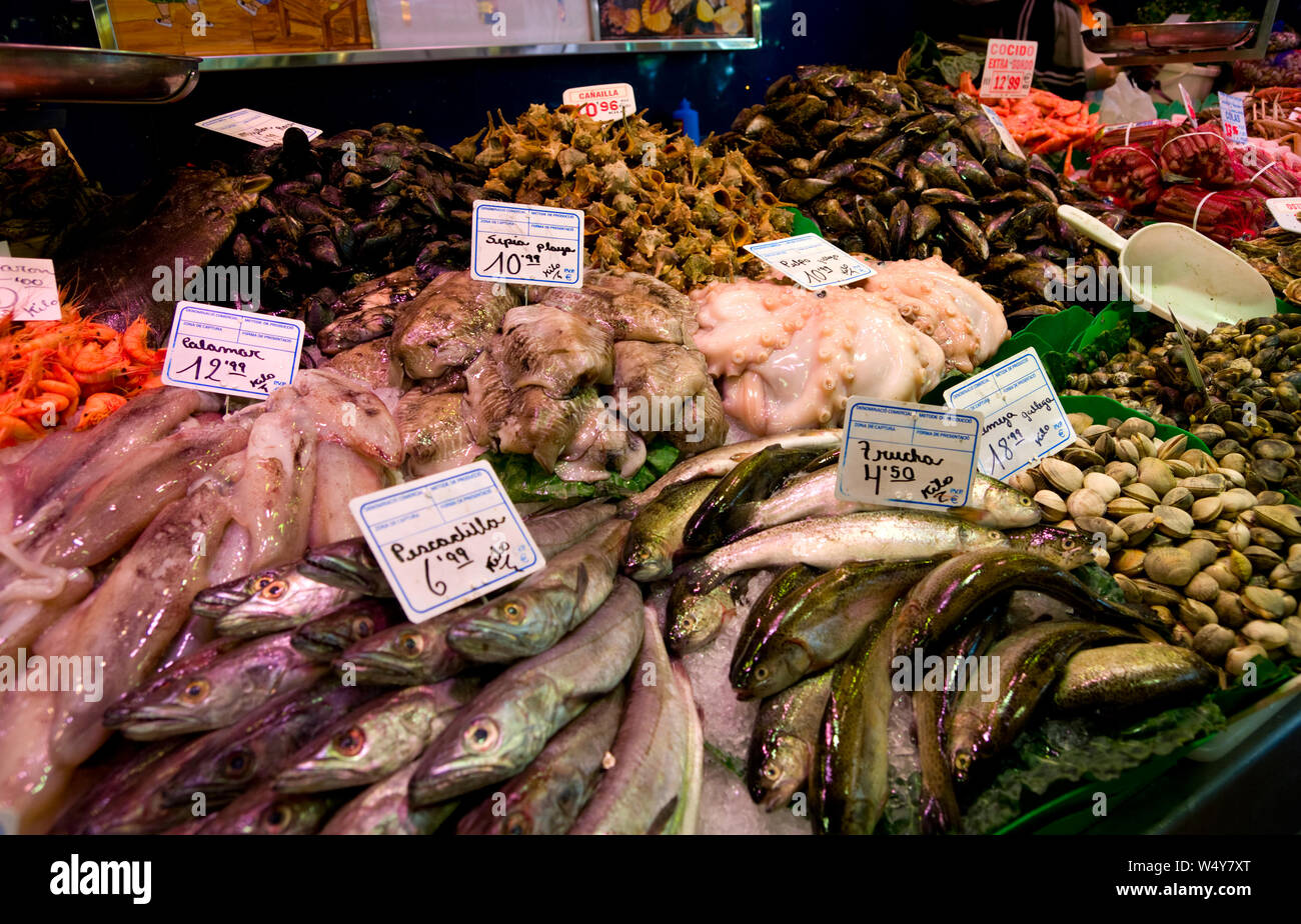 Boqueria mercato del pesce a Barcellona, Spagna. Stallo del mercato con una varietà di prodotti mediterranei - pesce, gamberi, crostacei, calamari ecc. Foto Stock